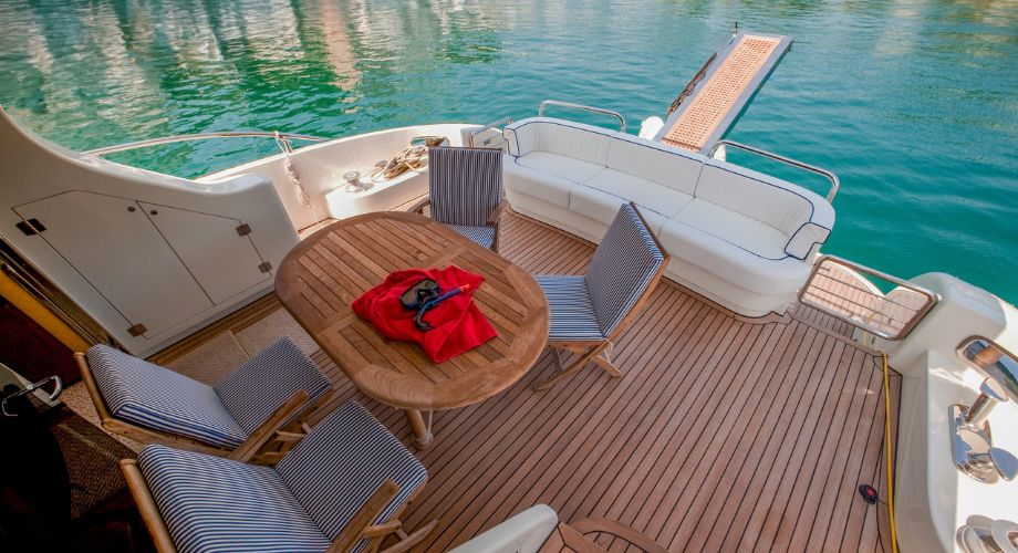 Yacht Deck | YATCO An outdoor wooden yacht deck of a luxury yacht sailing in the ocean. Learn about yacht decks, teak wood decking, prefabricated decks, and tips for maintaining luxury yacht deck surfaces.